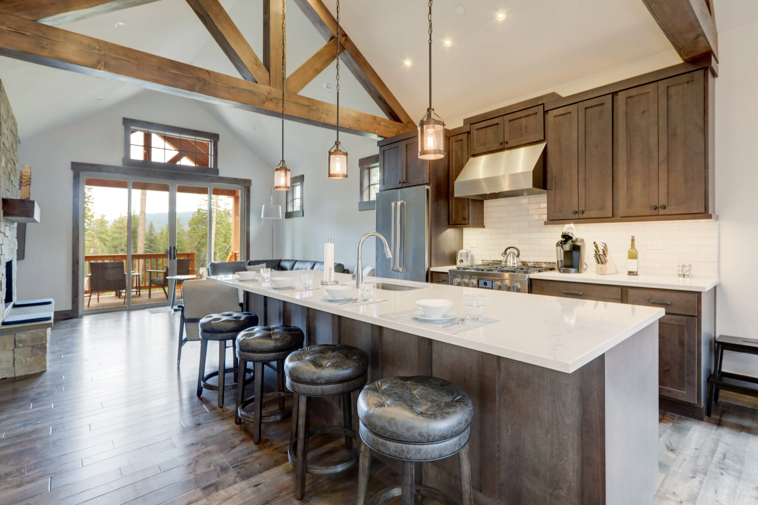 Amazing modern and rustic luxury kitchen with vaulted ceiling and wooden beams, long island with white quarts countertop.