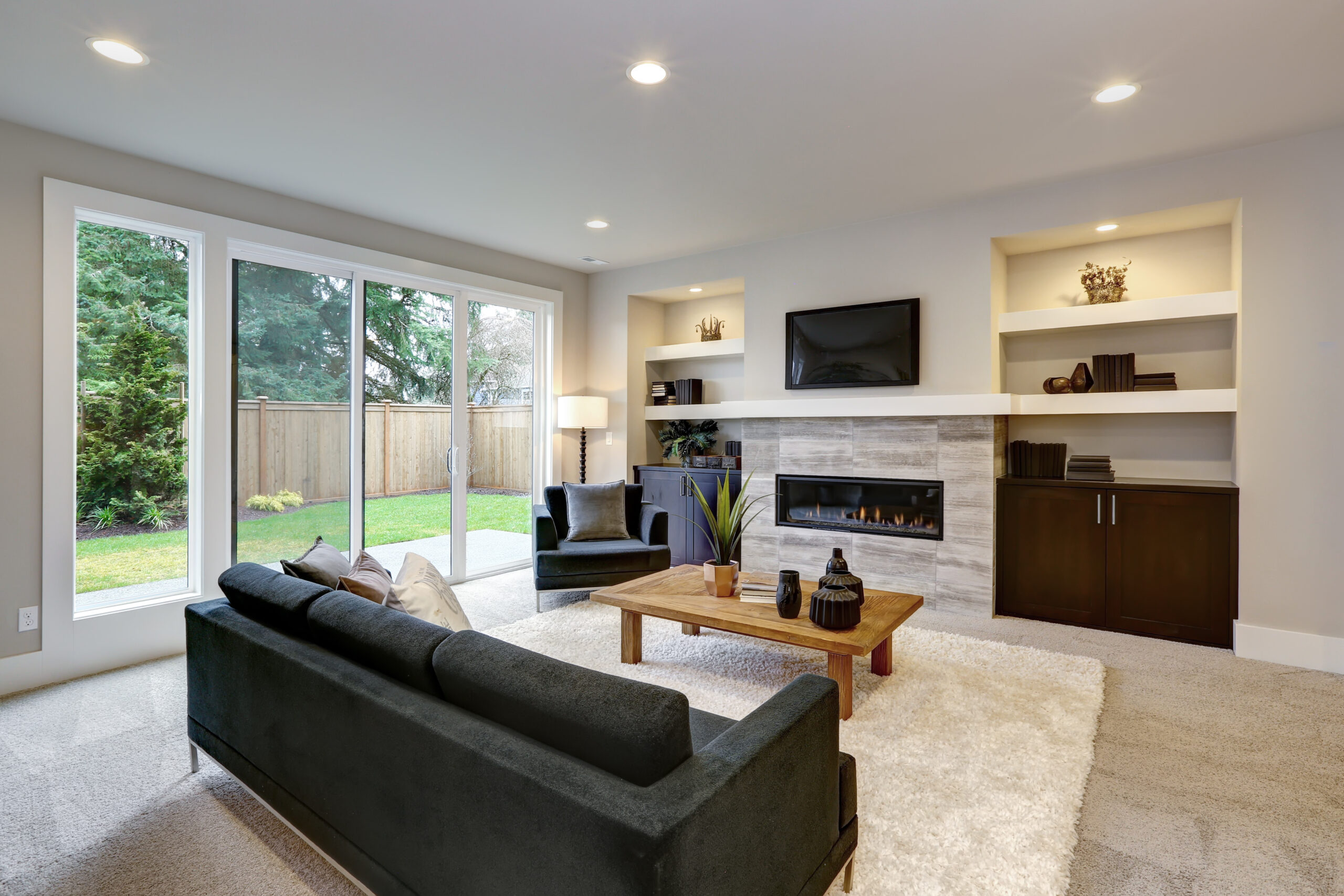 Beautiful modern living room interior with stone wall and firepl